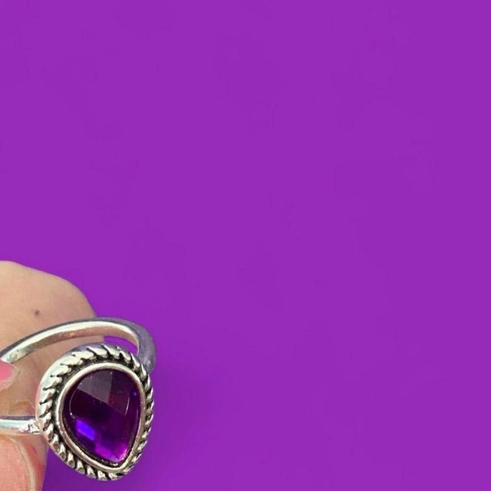 Amesyth style gemstone ring with a silver toned band.
